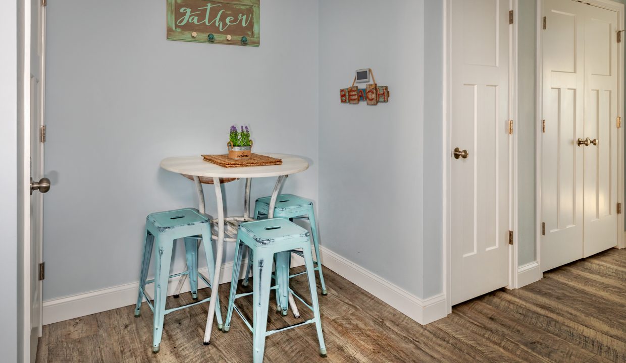 a kitchen with a table and four stools.