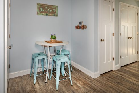 a kitchen with a table and four stools.