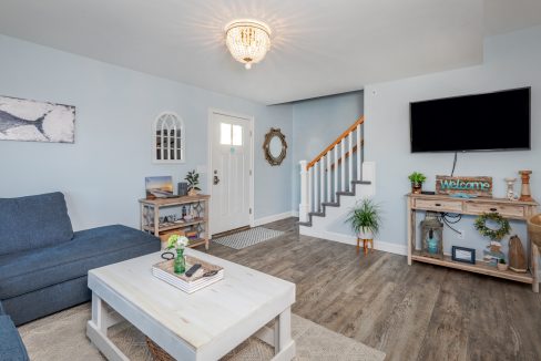 a living room filled with furniture and a flat screen tv.