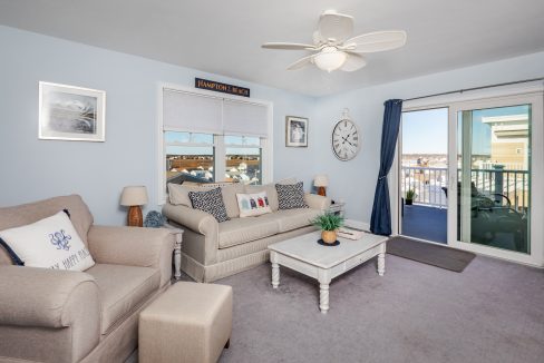 a living room filled with furniture and a large window.