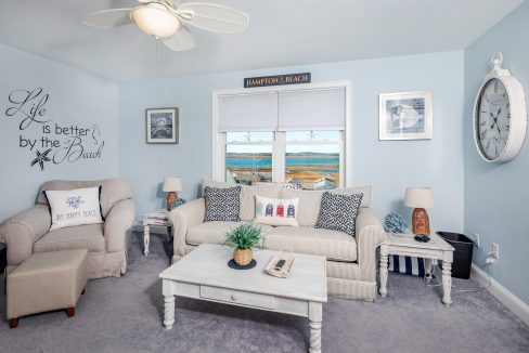 a living room filled with furniture and a clock on the wall.