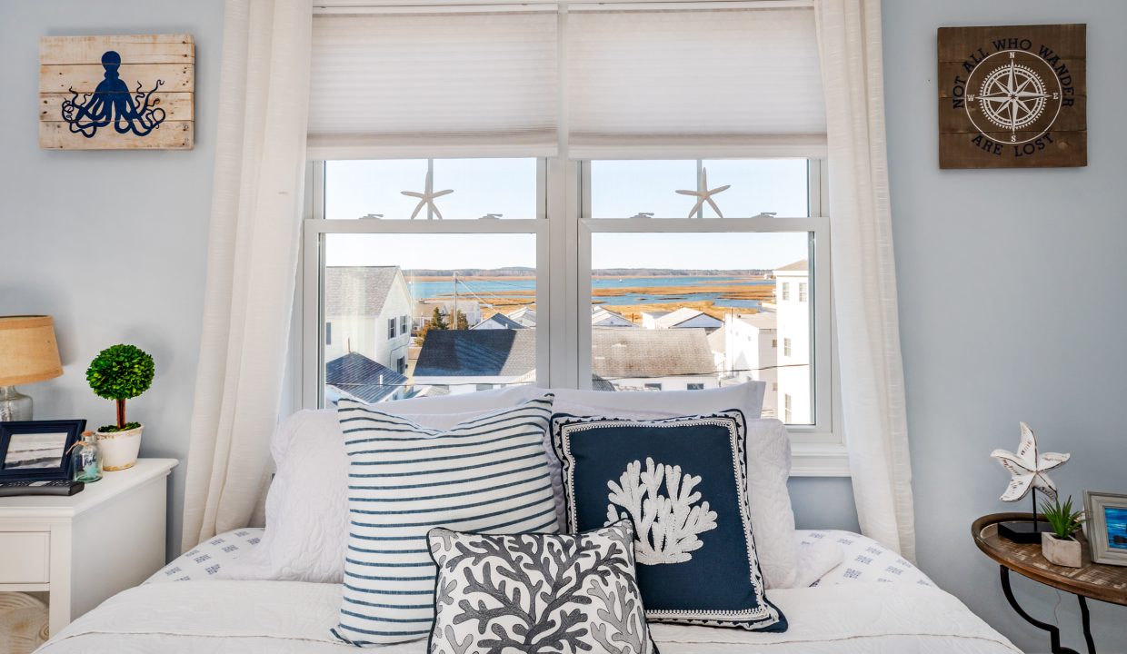 a bedroom with a bed and a window.