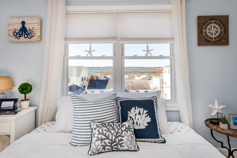 a bedroom with a bed and a window.