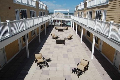 a row of chairs sitting on top of a patio.