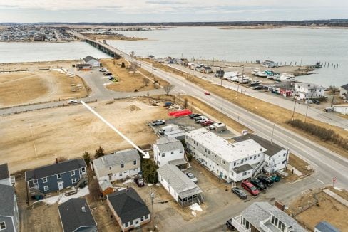 an aerial view of a town by the water.