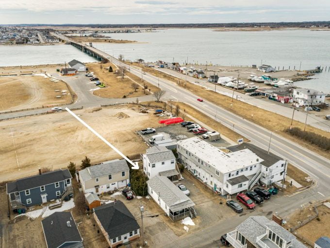 an aerial view of a town by the water.