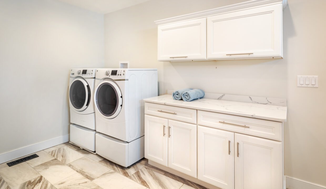 a washer and dryer in a white laundry room.