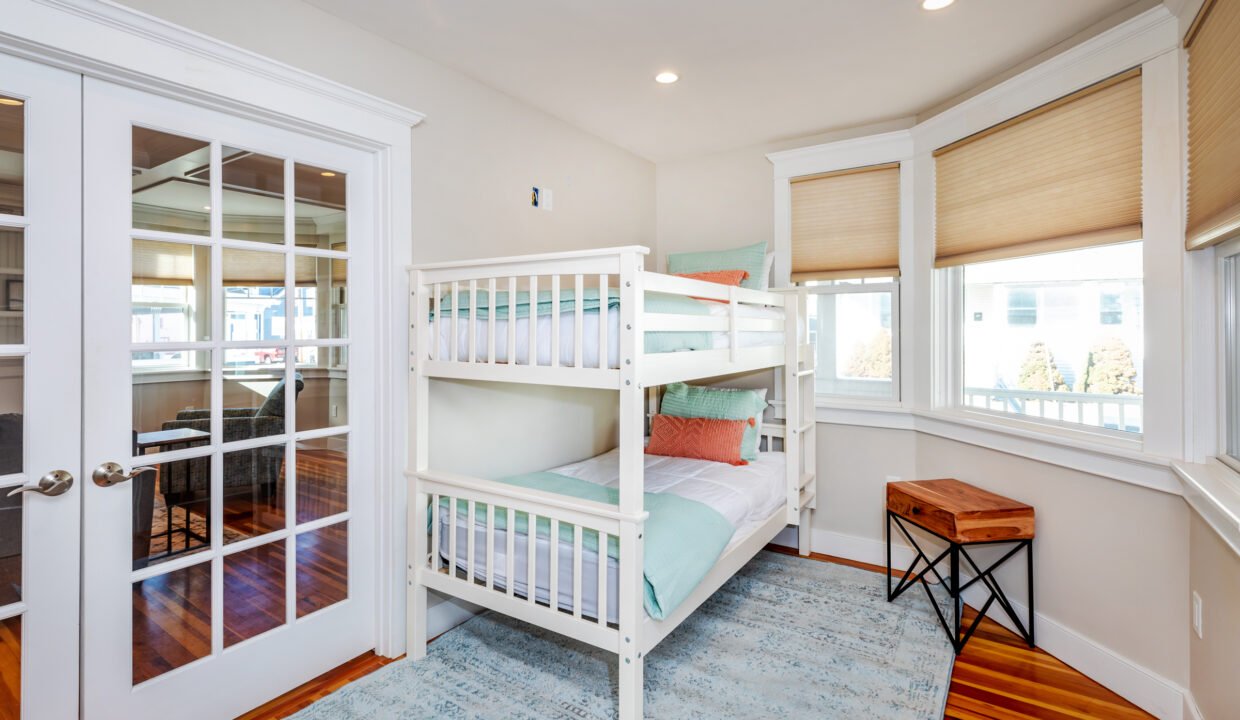 a bedroom with a bunk bed and a desk.