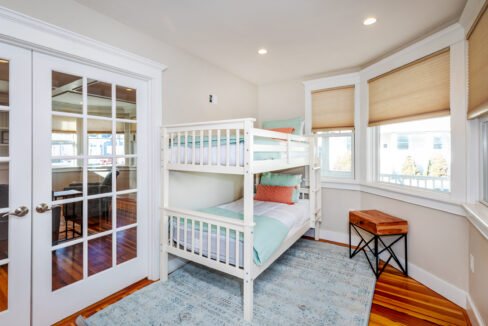 a bedroom with a bunk bed and a desk.