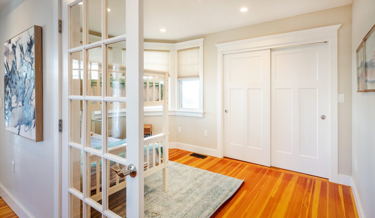 a room with a wooden floor and a white door.