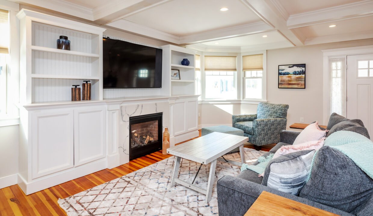 a living room filled with furniture and a fire place.