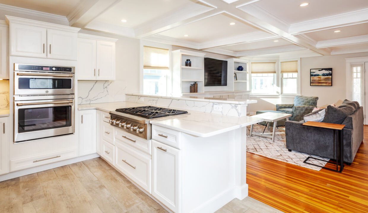 a kitchen with a stove and a couch in it.