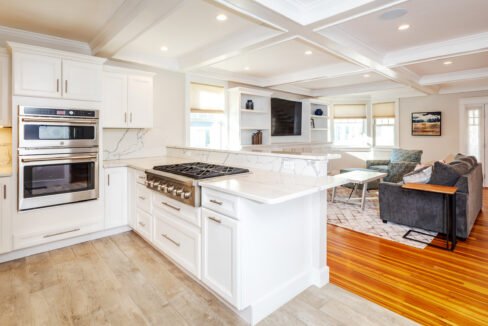 a kitchen with a stove and a couch in it.