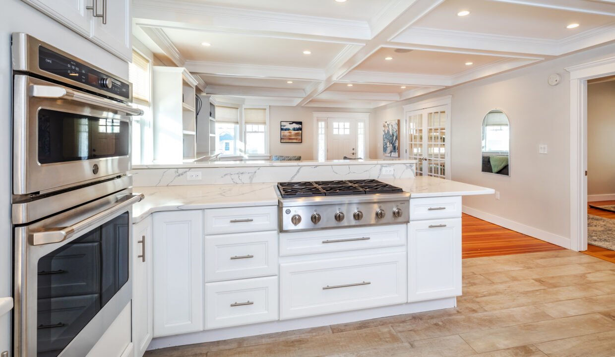 a kitchen with a stove, oven, microwave and cabinets.