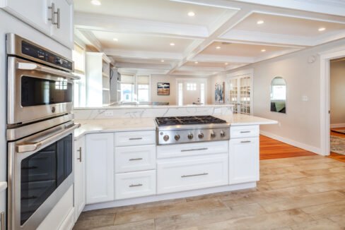 a kitchen with a stove, oven, microwave and cabinets.