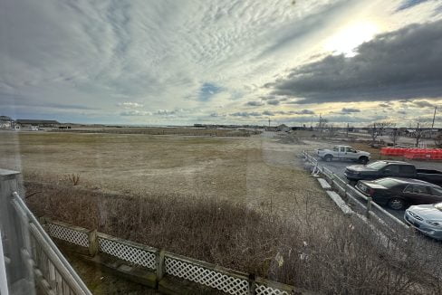 a parking lot filled with lots of parked cars.