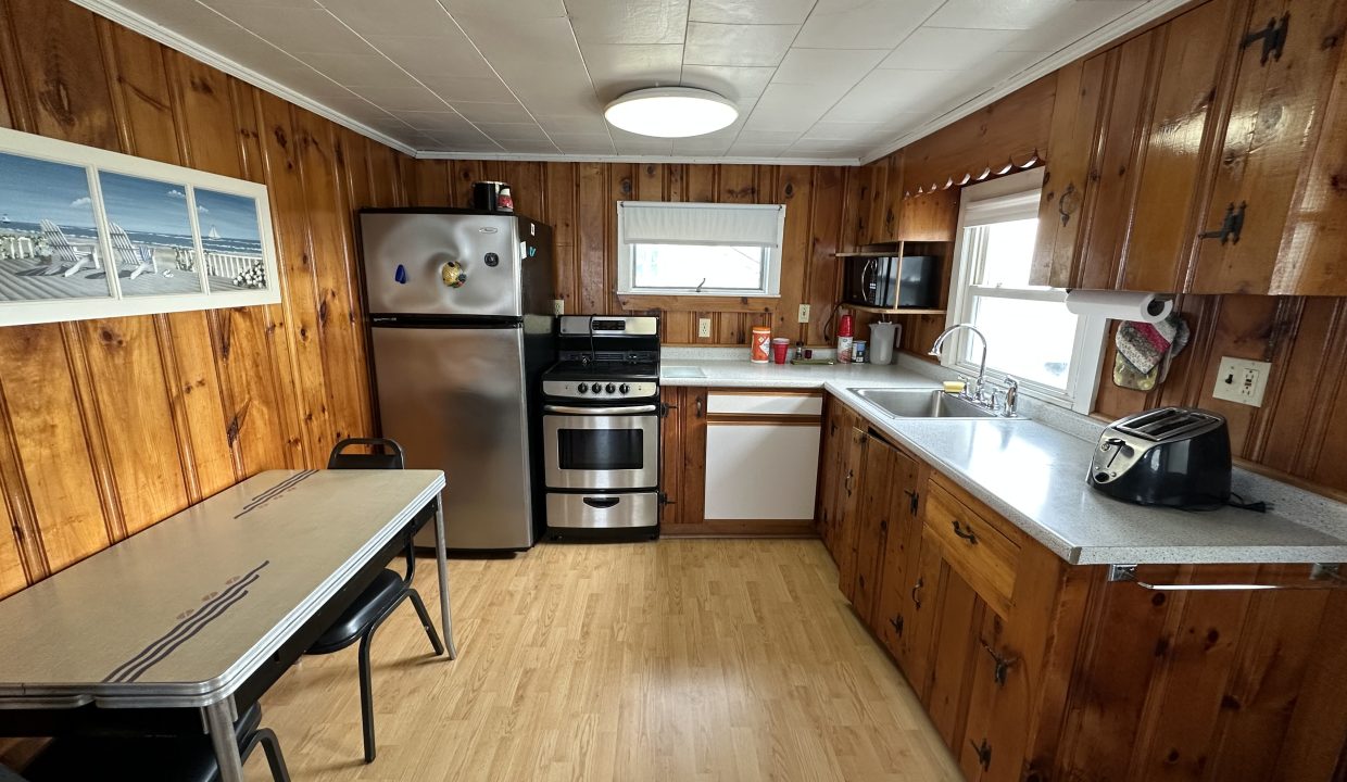 a kitchen with wood paneling and stainless steel appliances.