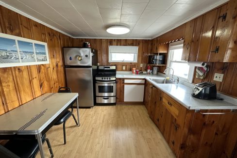a kitchen with wood paneling and stainless steel appliances.