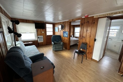 a living room filled with furniture and a hard wood floor.