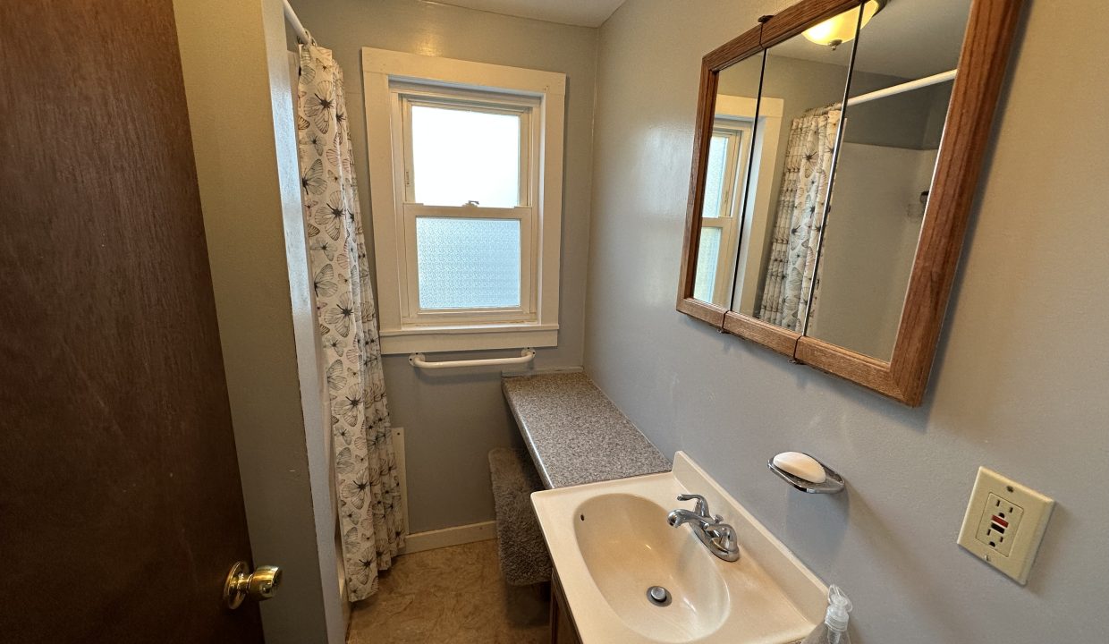 a bathroom with a sink and a mirror.