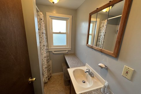 a bathroom with a sink and a mirror.