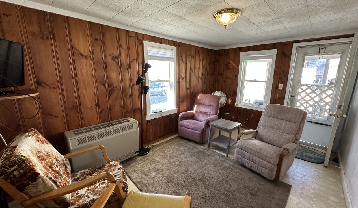 a living room filled with furniture and a flat screen tv.