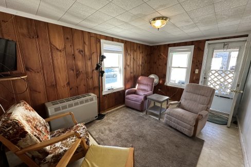 a living room filled with furniture and a flat screen tv.