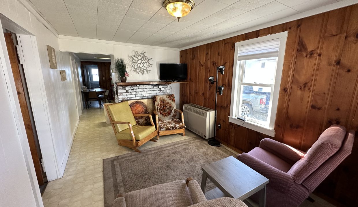 a living room filled with furniture and a flat screen tv.