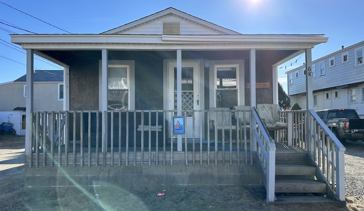 a house with a porch and a white fence.