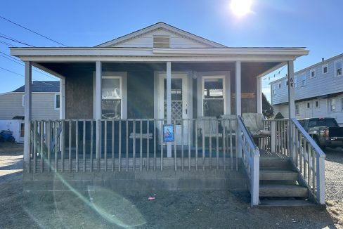 a house with a porch and a white fence.