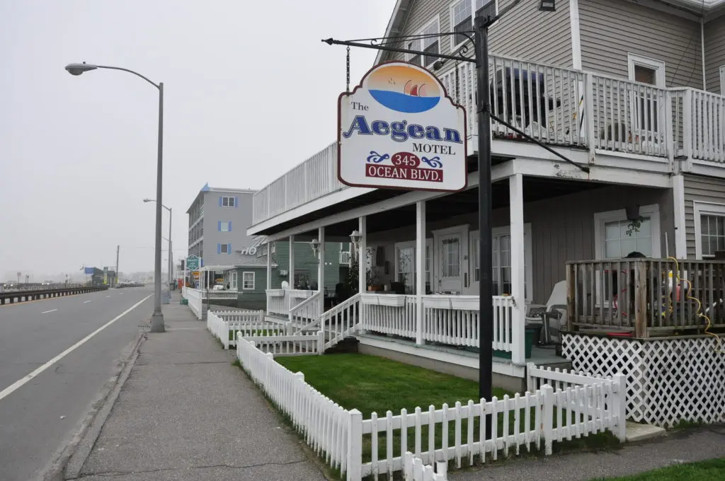 a white picket fence next to a building.