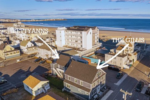 an aerial view of a beach town with the ocean in the background.