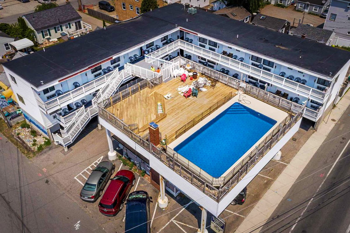 an aerial view of a building with a swimming pool.