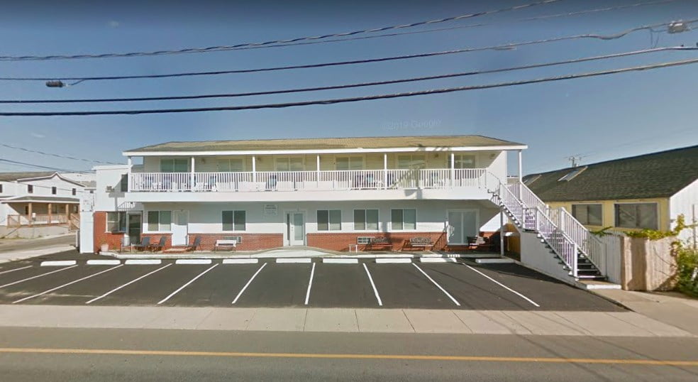 a white building with a red and white striped roof.