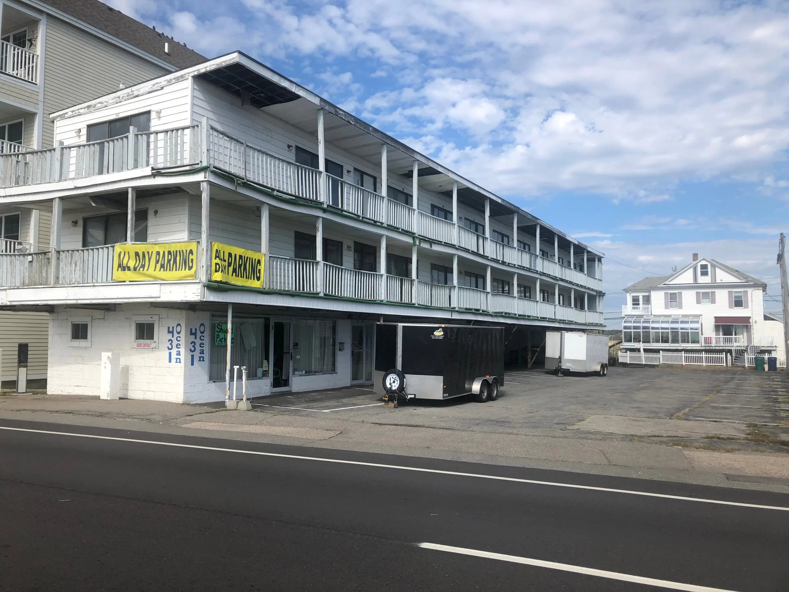 a parking lot with a car parked in front of a building.