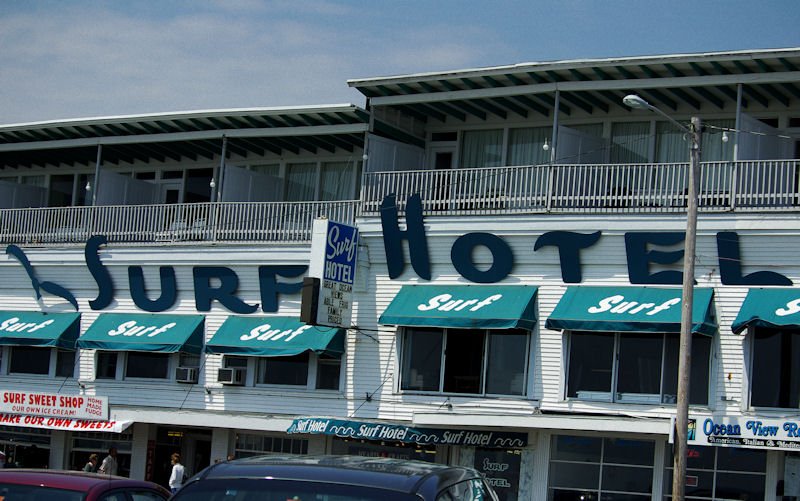 a hotel with a surf sign on the front of it.