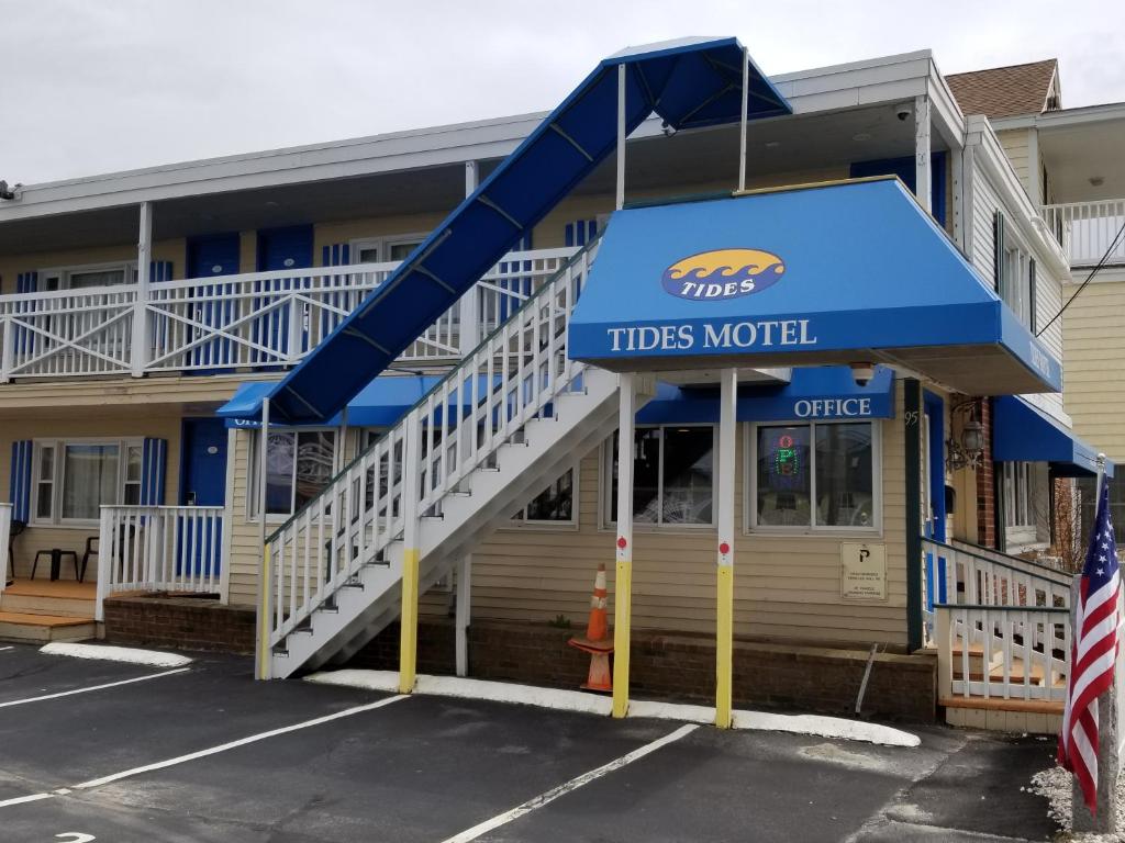 a hotel with a blue awning and stairs leading up to it.