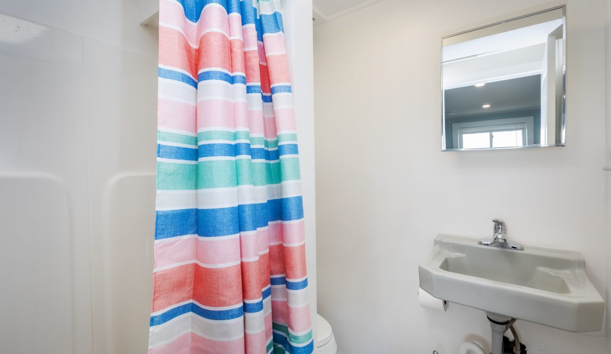 a bathroom with a colorful shower curtain.