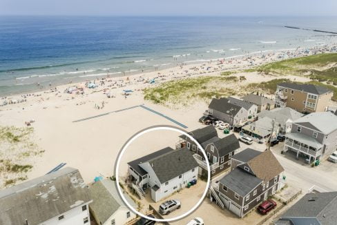 an aerial view of a house on the beach.