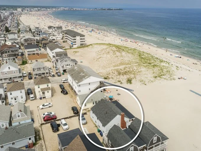 an aerial view of a house on the beach.