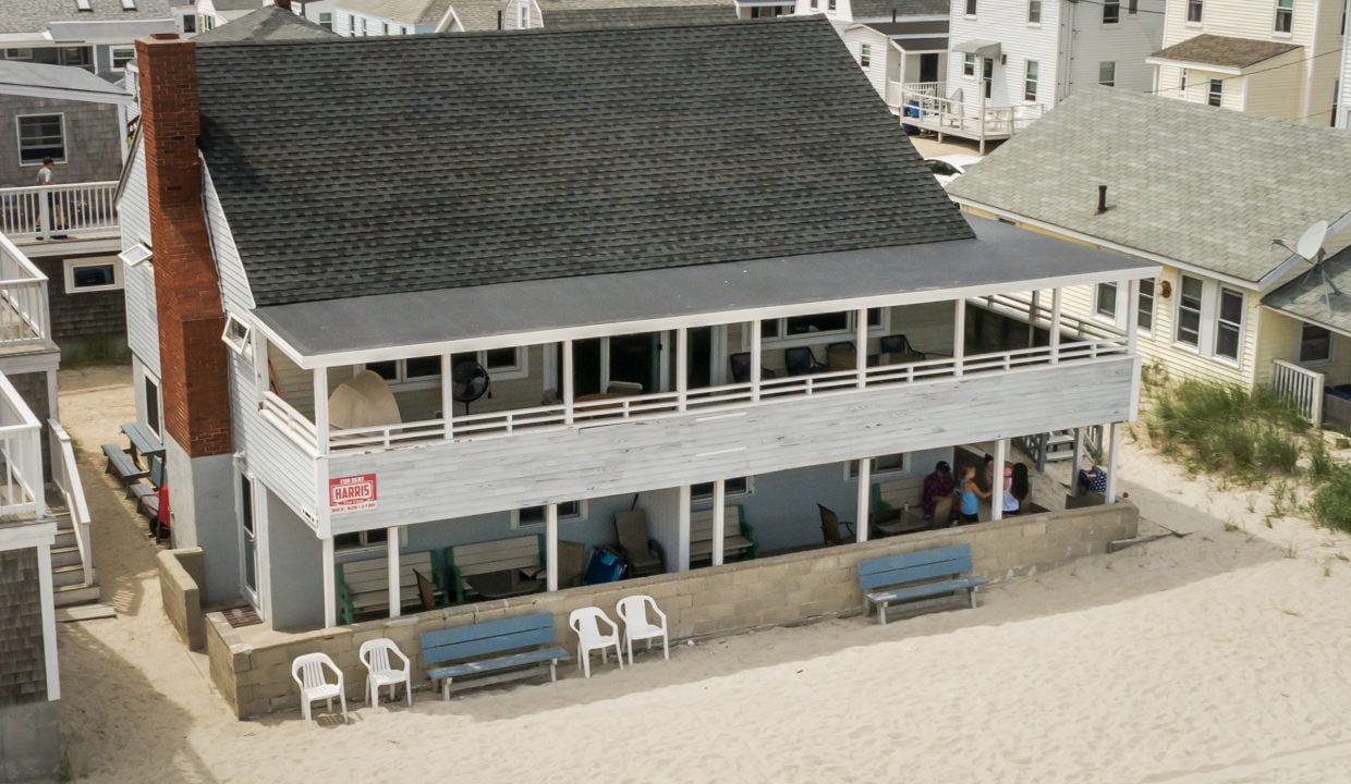 an aerial view of a house on the beach.