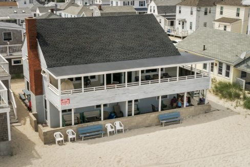 an aerial view of a house on the beach.