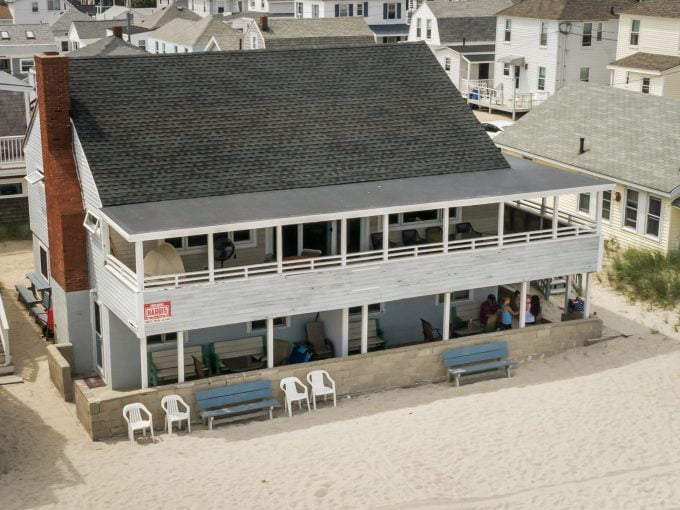 an aerial view of a house on the beach.