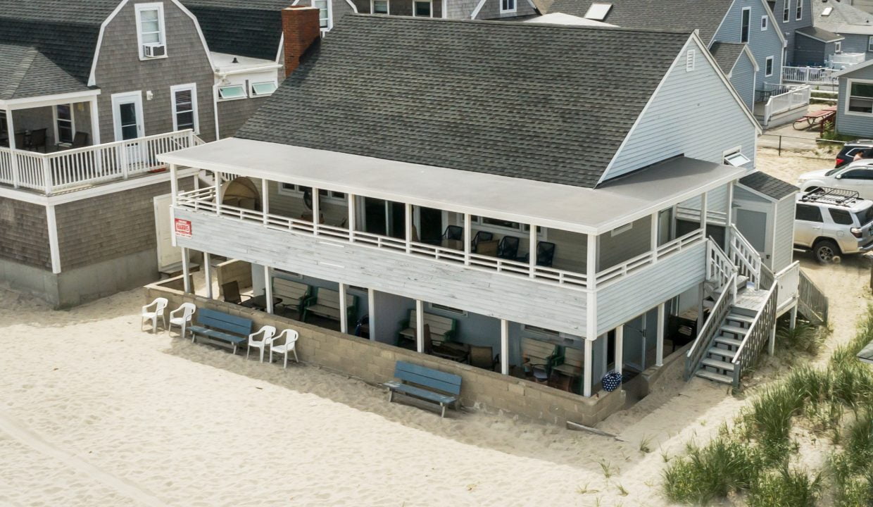 an aerial view of a house on the beach.