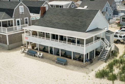 an aerial view of a house on the beach.