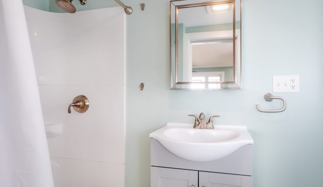 a small bathroom with a sink and shower.