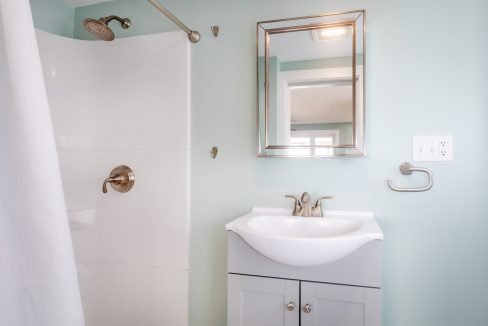 a small bathroom with a sink and shower.