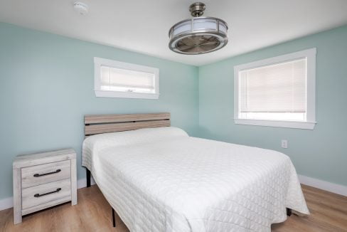 a bedroom with blue walls and a white bed.