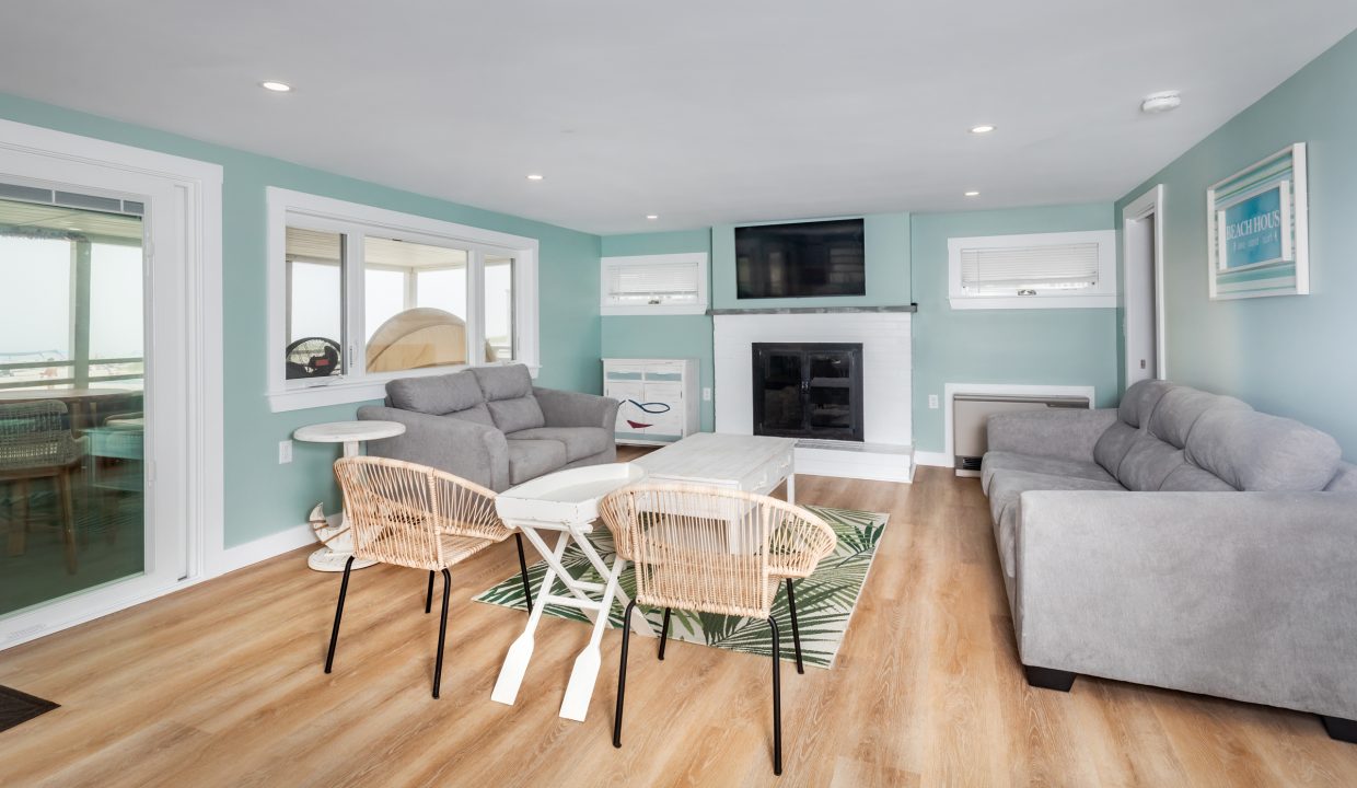 a living room with blue walls and white furniture.