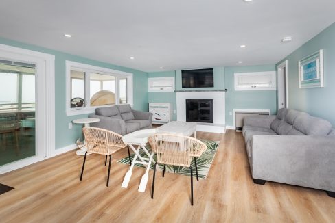 a living room with blue walls and white furniture.